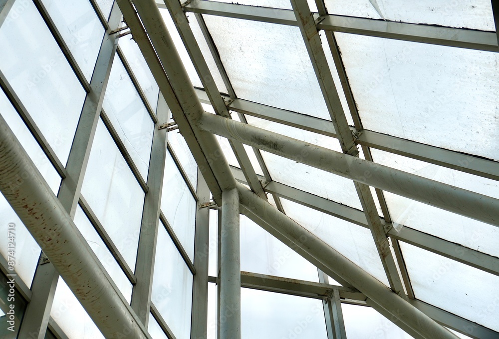 Indoor roof or ceiling surface with glass windows material isolated on horizontal ratio background. Green house or rumah kaca metal structure exterior.
