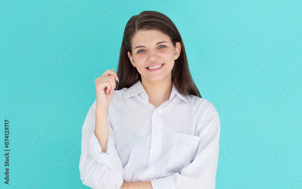 Young european woman, professional entrepreneur standing in office clothing, smiling and looking confident, blue background Young european woman, professional entrepreneur standing in office clothing, smiling and looking confident, blue background