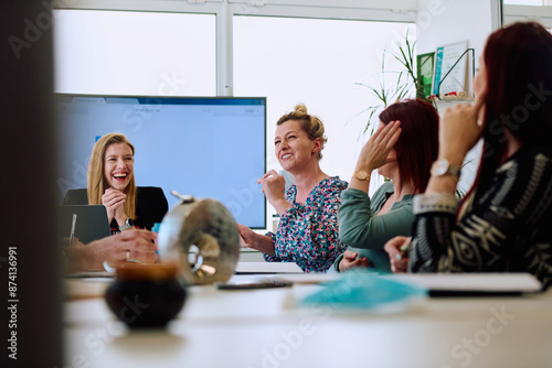 Diverse Business Team Discussing Projects in a Modern Glass Office. photo