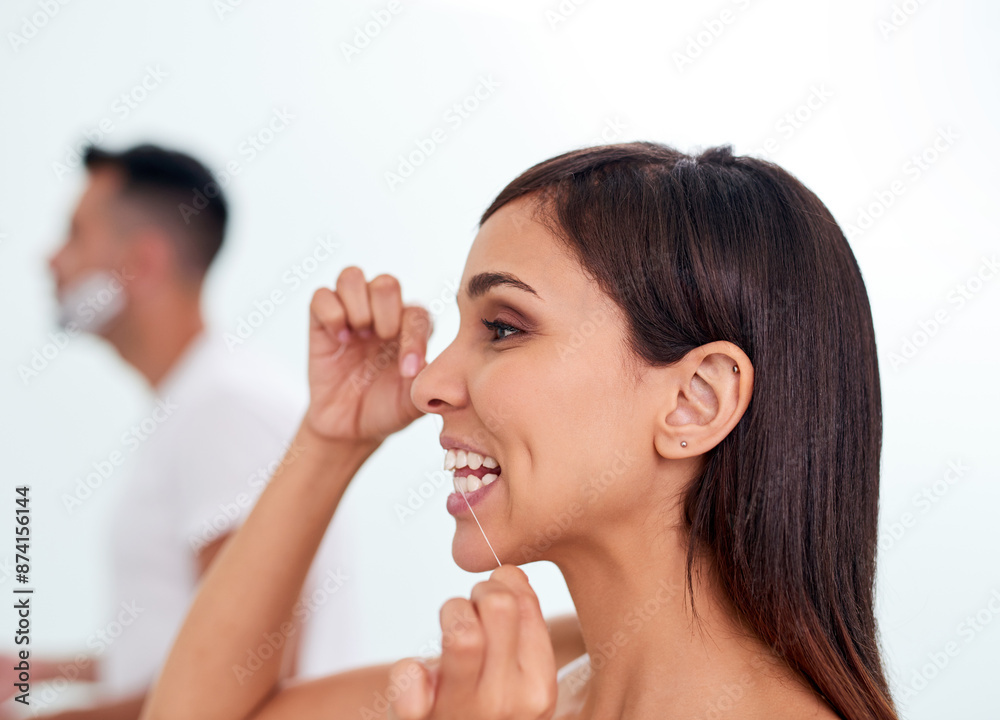 Woman, dental care and flossing teeth in home, orthodontics and cosmetics in bathroom. Female person, oral health and string for grooming in profile, cleaning and selfcare or thread for plaque Woman, dental care and flossing teeth in home, orthodontics and cosmetics in bathroom. Female person, oral health and string for grooming in profile, cleaning and selfcare or thread for plaque