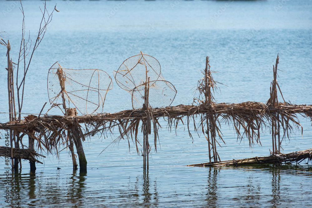 Reed fish traps and metal cages a typical method of fishing along the River Nile at Rosetta in the Nile Delta of North Egypt Reed fish traps and metal cages a typical method of fishing along the River Nile at Rosetta in the Nile Delta of North Egypt