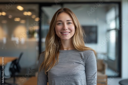 Portrait of a happy woman in her 30s sporting a long-sleeved thermal undershirt in front of sophisticated corporate office background Free Download Portrait of a happy woman in her 30s sporting a long-sleeved thermal undershirt in front of sophisticated corporate office background - GFXLoad