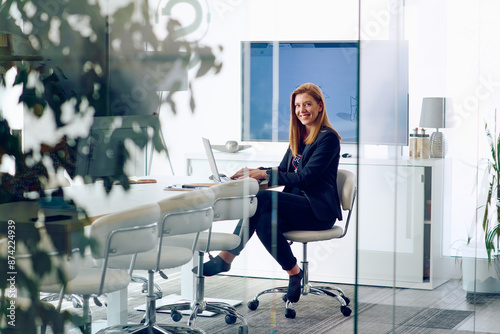 Businesswoman Working on Projects in Modern Glass Office Environment.