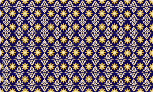 Thai applied ethnic pattern in golden yellow with floral patterns on a dark blue background.