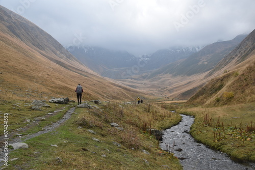 Canvas Print Silhouette of a hiker in rain clothes in some misty mountains in Georgia