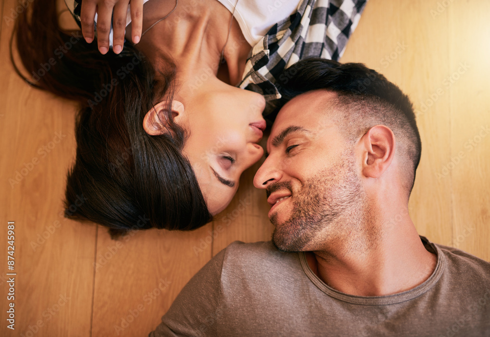 Couple, floor and kiss for relax in home, living room and ground of new house. Property investment, purchase and top view of excited man and female person, married and mortgage or real estate project Couple, floor and kiss for relax in home, living room and ground of new house. Property investment, purchase and top view of excited man and female person, married and mortgage or real estate project