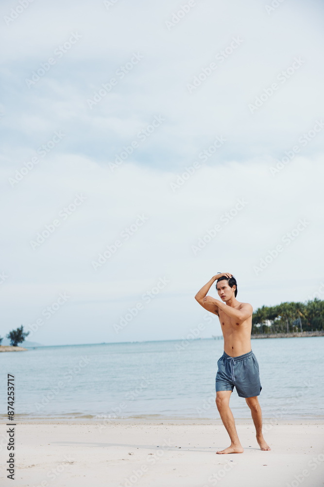 Active Asian Athlete Running on the Beach at Sunset, Exuding Strength and Power in a Muscular Body Active Asian Athlete Running on the Beach at Sunset, Exuding Strength and Power in a Muscular Body