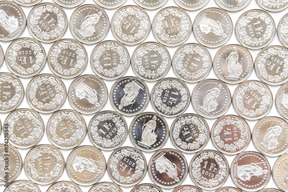coins linearly spread on white background