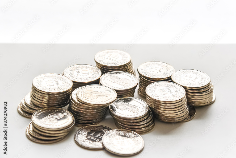 stack of coins spread on white background