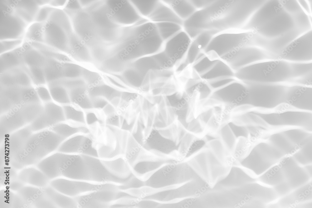 White water with ripples on the surface. Defocus blurred transparent white colored clear calm water surface texture with splashes and bubbles. Water waves with shining pattern texture background.