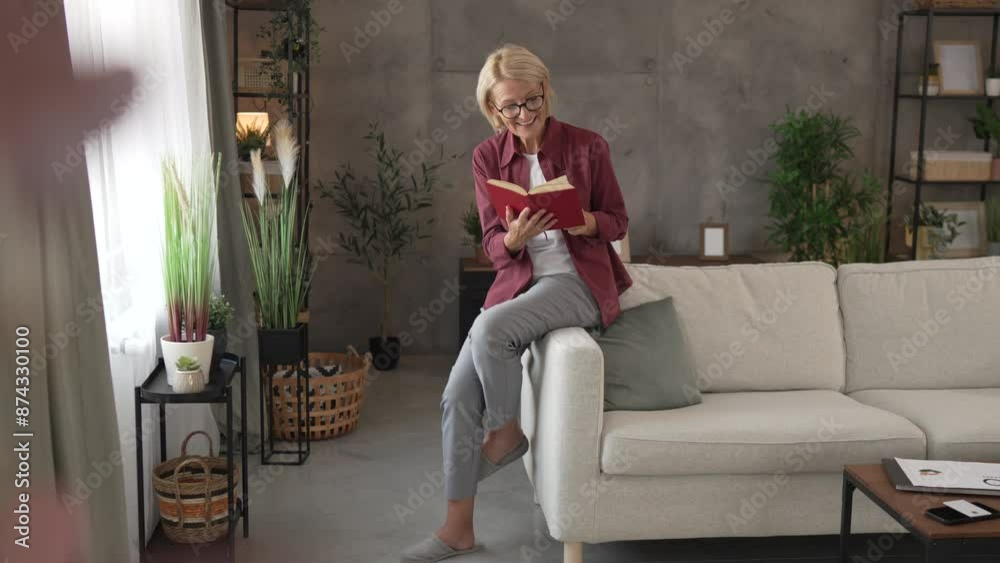 Mature senior relax woman sit in the living room and read a book Mature senior relax woman sit in the living room and read a book