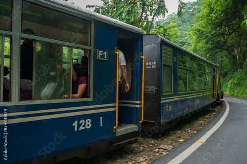 Darjeeling,West Bengal,India - 10th August 2023 : Diesel Toy train passing through Himalayan roads and jungle. Darjeeling Himalayan Railway, narrow gauge railway between New Jalpaiguri and Darjeeling.