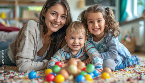A woman and two children with colorful balls showing joy, playfulness, and family bonding