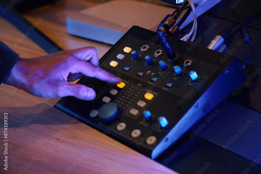 Close-up of sound engineer pressing button on control panel to make a sound for new song Close-up of sound engineer pressing button on control panel to make a sound for new song