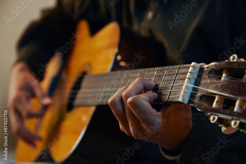 Close-up of guitarist playing guitar in studio