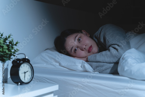 Anxiety disorder on insomnia woman concept, sleepless Woman open eye awakening on the bed at night time can't sleep from symptom of depression diseased.