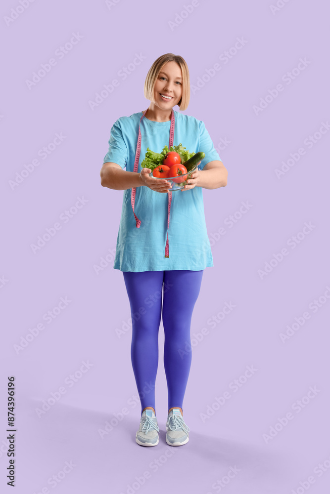 Pretty young woman with measuring tape and fresh vegetables on lilac background. Weight loss concept Pretty young woman with measuring tape and fresh vegetables on lilac background. Weight loss concept