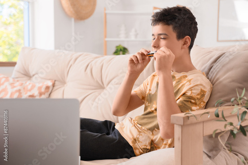 Teenage boy playing harmoni...
