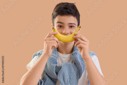 Teenage boy with banana on ...