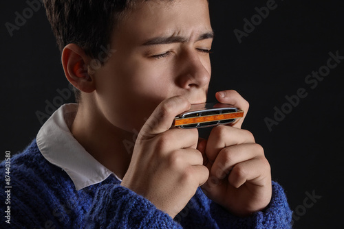 Teenage boy playing harmoni...