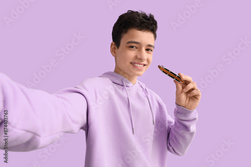 Teenage boy with harmonica ...