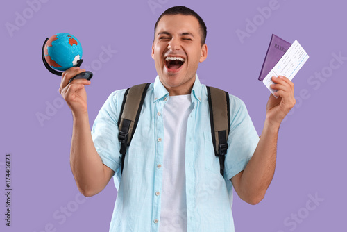 Happy male tourist with glo...