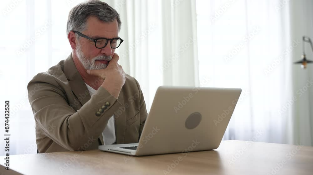 Mature businessman ceo trader using computer, typing, working in modern office, doing online data market analysis, thinking planning tech strategy looking at laptop with copy space. Mature businessman ceo trader using computer, typing, working in modern office, doing online data market analysis, thinking planning tech strategy looking at laptop with copy space.