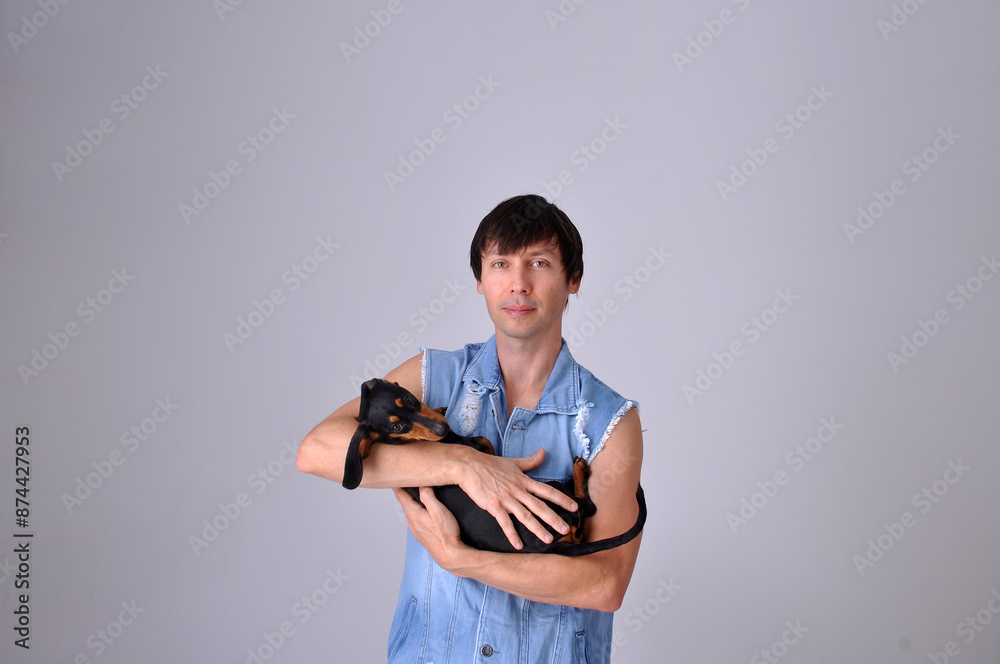 homem vestindo roupas jeans com cachorro fofo cachorro salsisha duchshund homem vestindo roupas jeans com cachorro fofo cachorro salsisha duchshund