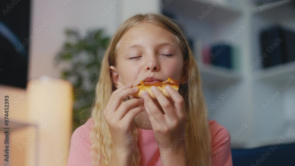 Young girl enjoying a slice of pizza at home, junk food for lunch, weekend Young girl enjoying a slice of pizza at home, junk food for lunch, weekend
