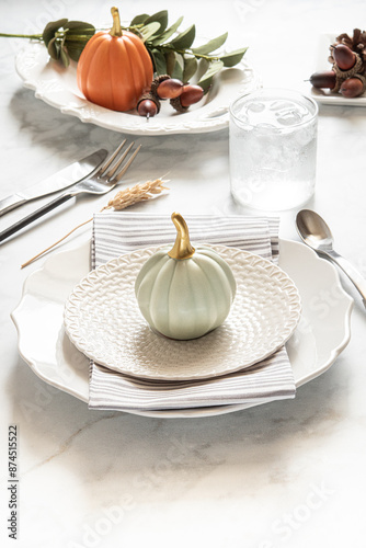 Slika na platnu Thanksgiving tablescape on a white marble backdrop with plates, table napkins, and cutlery