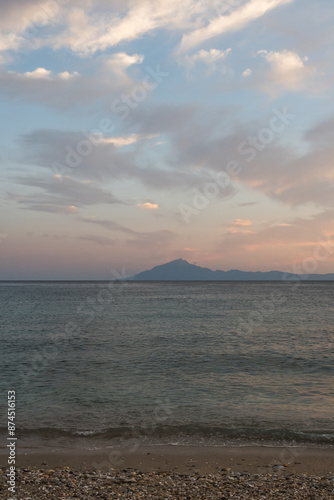 View across the sea from the island of Thassos to distant Mount Athos at sunset