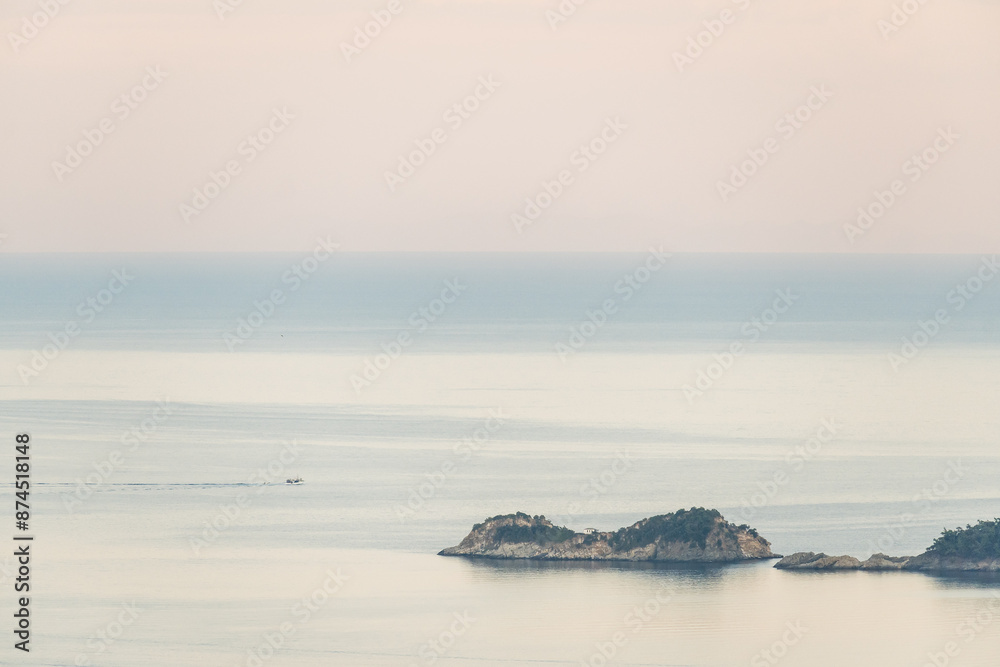 A small island near a Golden Beach on the island of Thasos, Greece A small island near a Golden Beach on the island of Thasos, Greece