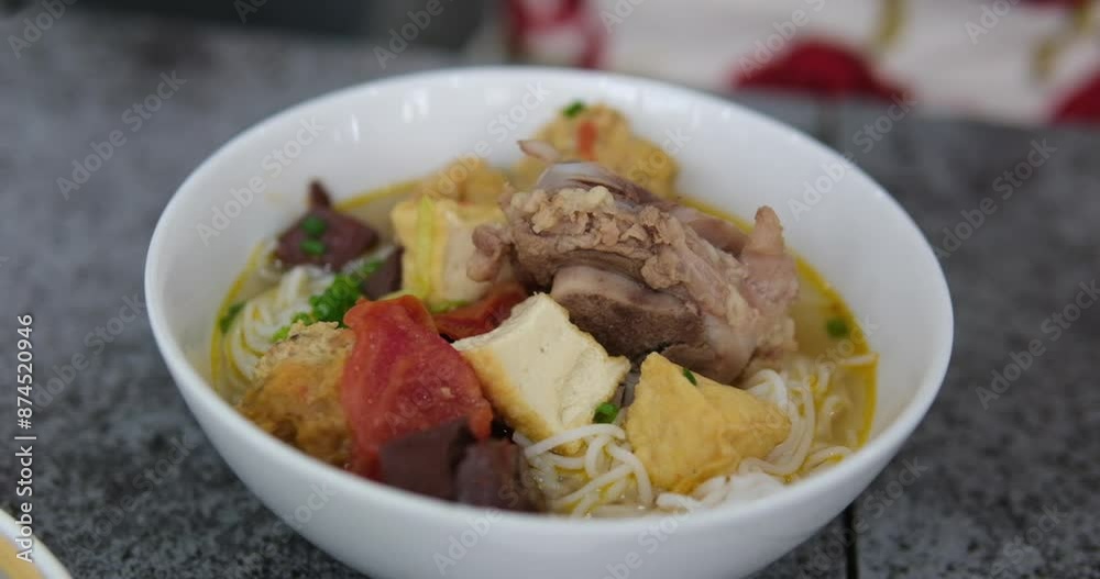 Vertical video of Tom Yam kung Spicy Thai asian soup with shrimp, rice seafood, coconut milk and chili pepper in bowl, close up of traditional cuisine in restaurant Vertical video of Tom Yam kung Spicy Thai asian soup with shrimp, rice seafood, coconut milk and chili pepper in bowl, close up of traditional cuisine in restaurant