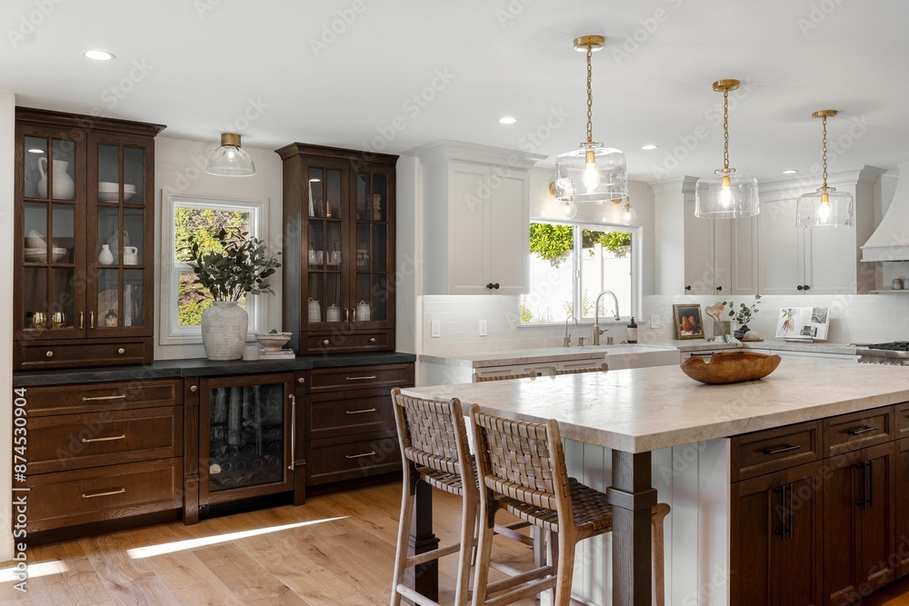 Modern kitchen interior with wooden cabinets, island, and pendant lighting.