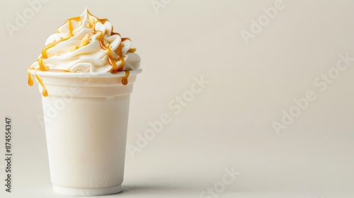 A creamy frappuccino topped with whipped cream and drizzled with caramel, perfect for a refreshing treat with copy space
