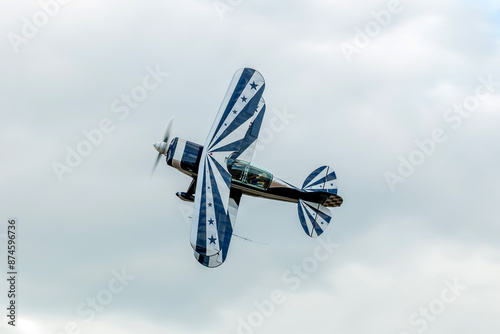 The practice of model airplanes in aerobatics for display at events held by flying clubs around the world with a beautiful biplane airplane photo