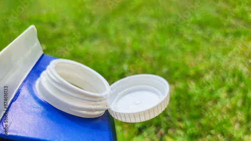 Open Milk Carton on Green Grass