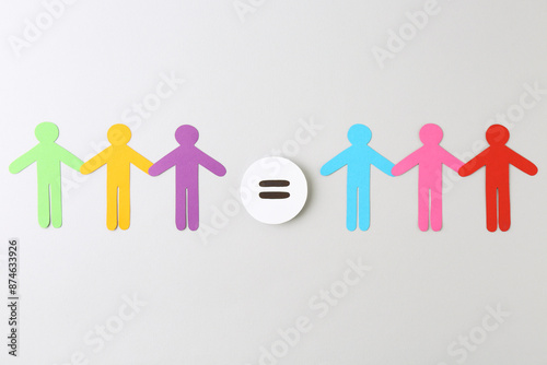 Paper human figures and equals sign on light background, flat lay
