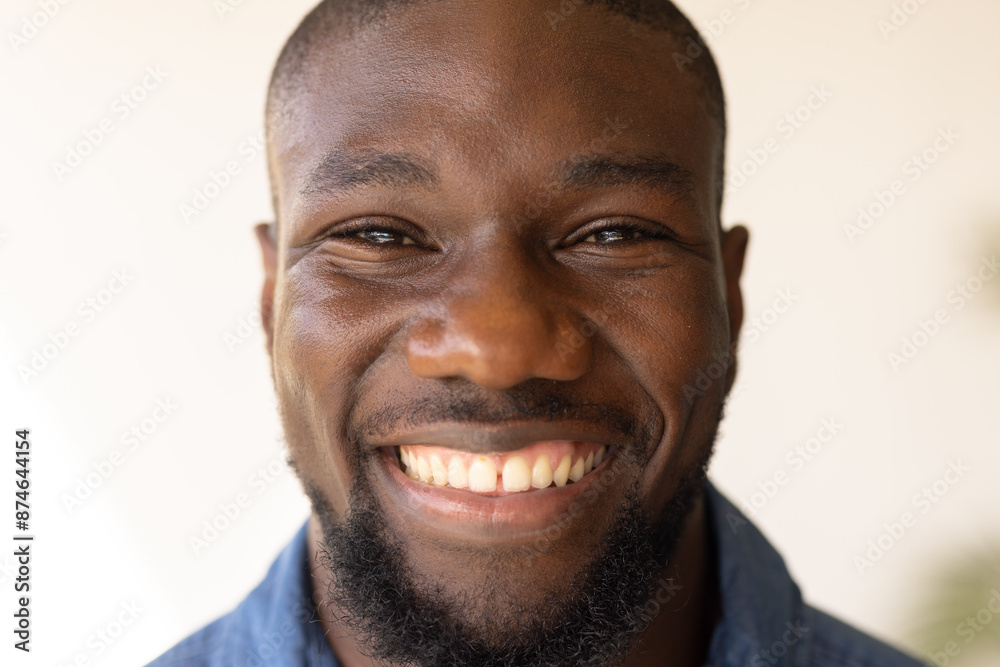 Smiling man enjoying relaxation at home, feeling happy and content Smiling man enjoying relaxation at home, feeling happy and content