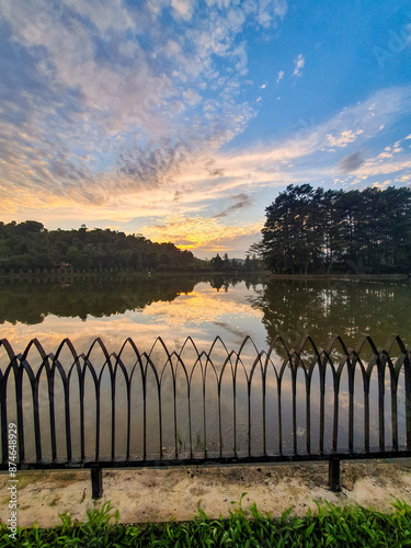 Beautiful sunrise with sky reflection of situ Wanayasa. One of spot tourism destination of Purwakarta West Java Indonesia.  photo