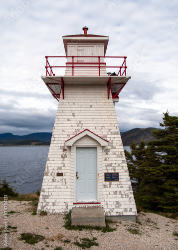 The Woody Point Lighthouse, at a height of 7.3 meters, is a square, tapered wooden tower clad in shingles, topped with a traditional square lantern. 