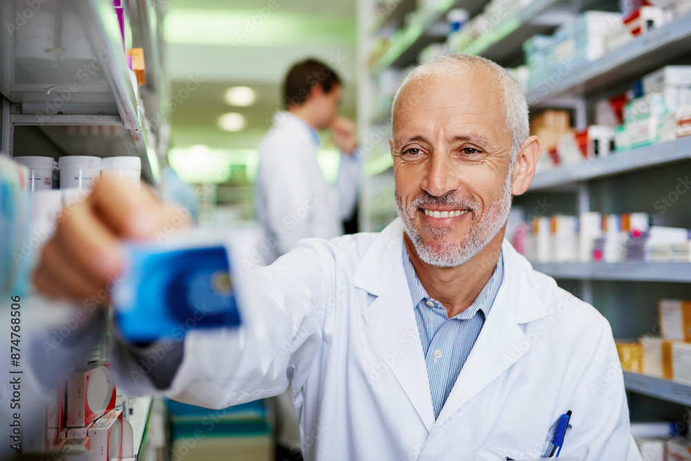 Obraz premium Box, medicine and happy man in pharmacy for healthcare, wellness and service for retail. Pharmacist, mature and package for pills or supplements in hospital for inspection, information or check label