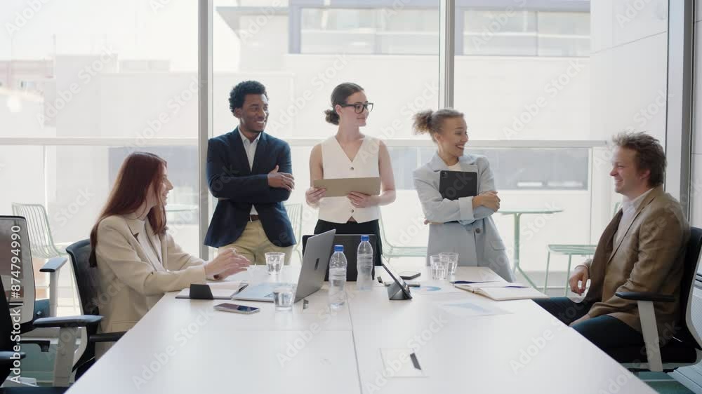 A diverse group of young professionals collaborate during a successful ...
