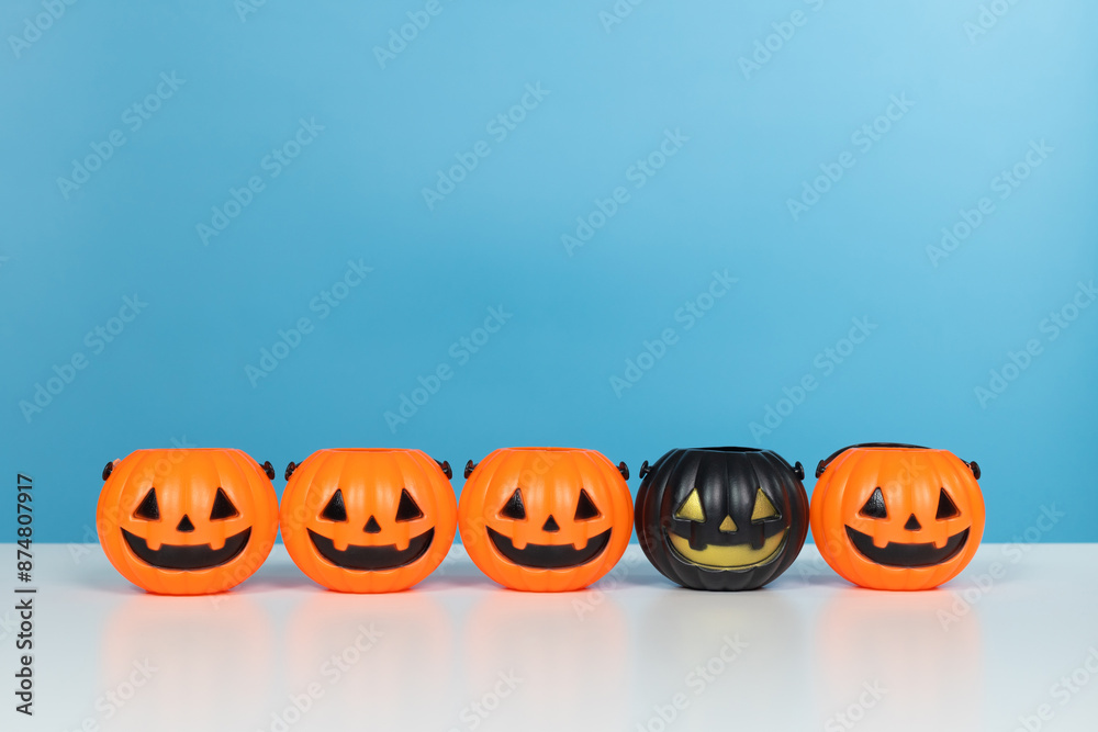 Halloween and decoration concept. Pumpkins orange and black on table with blue background. Jack o lantern pumpkin decoration on wooden table Halloween and decoration concept. Pumpkins orange and black on table with blue background. Jack o lantern pumpkin decoration on wooden table