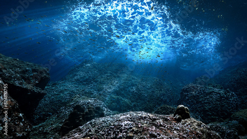 Photos Underwater photo of rays of sunlight in blue colors coming through the surface over a reef