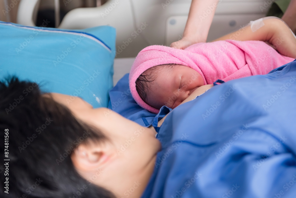 Cute newborn baby girl on nurse hands feed breastmilk by mom Cute newborn baby girl on nurse hands feed breastmilk by mom
