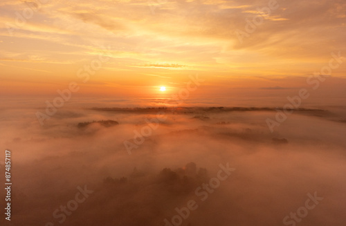 A beautiful misty morning aerophotography of rural landscape in Latvia. Natural summer scenery in Northern Europe.