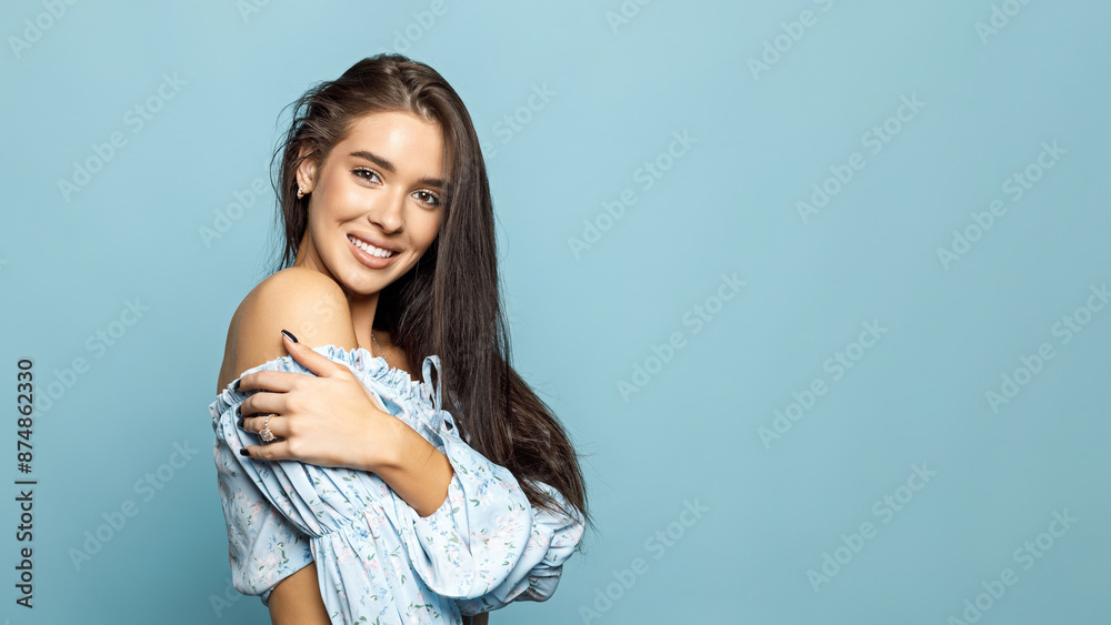 Beautiful Young Brunette Woman Model In Summer Blue Clothes Posing on a Blue Background. White Teeth, Wide Smile. Beautiful Young Brunette Woman Model In Summer Blue Clothes Posing on a Blue Background. White Teeth, Wide Smile.