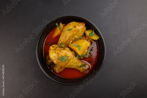 Murgir Jhol or Bengali Chicken Curry is Spicy, delecious and Soupy Chicken Curry With Potatoes. photo