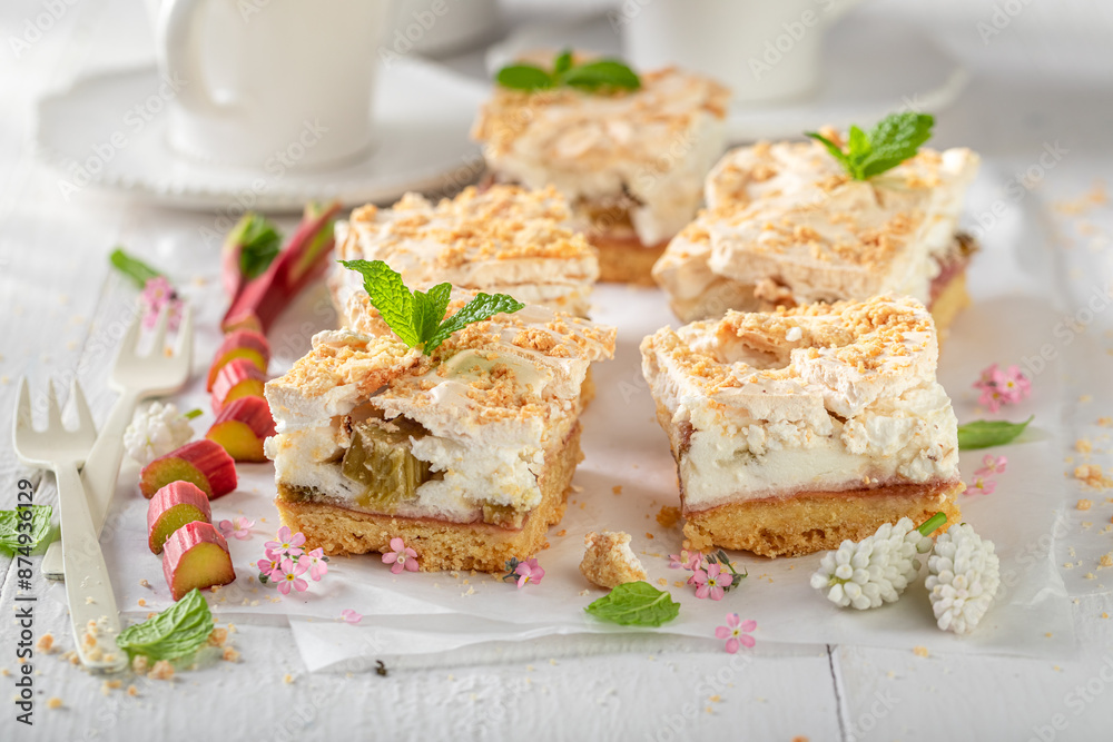 Homemade and tasty rhubarb yeast cake served with tea. Homemade and tasty rhubarb yeast cake served with tea.